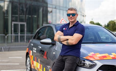 Vairavimo instruktorius moko mokinį automobilio vairavimo subtilybių. Fokusas į saugų vairavimą