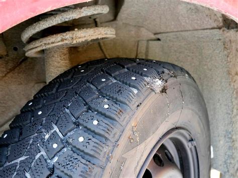 automobilis su dygliuotomis padangomis važiuojantis per sniegą