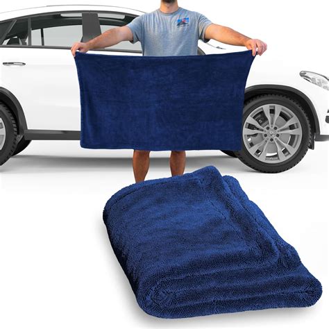 Photo of a car being dried with a soft microfiber towel