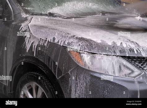 Photo of a car engine being carefully washed with protective covers on electrical components