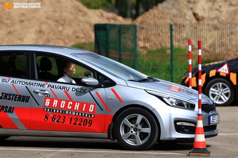 Vairavimo instruktoriaus ir mokinio diskusija automobilyje