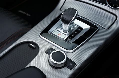 Thematic photo of a car's gear lever with an emphasis on its blocking mechanism