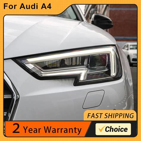 The headlights on a black Audi A4 with LED DRLs illuminated, showing the projector lens