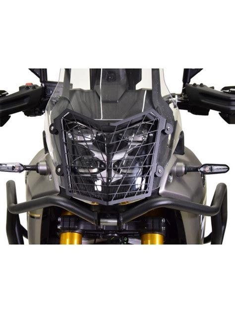 Teminis motociklo priekinio žibinto nuotrauka, apšviečianti kelią