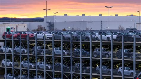 Teminis paveikslėlis, vaizduojantis modernią automobilių gamyklos surinkimo liniją su robotais.