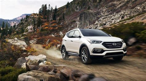 The Hyundai Santa Fe driving on a scenic road, highlighting its design and presence.
