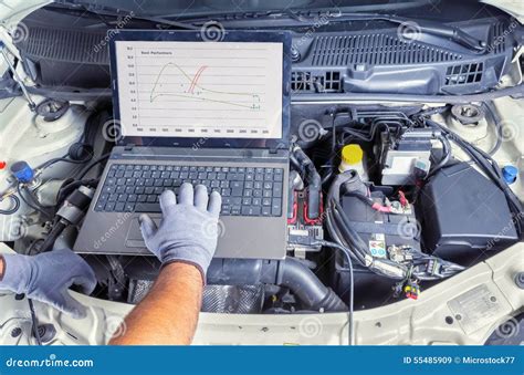 Mechanic performing computer diagnostics on a car's steering system.
