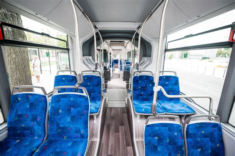 Tematinis paveikslas: mokyklinio autobuso vidus su vaikais, prisisegusiais saugos diržus