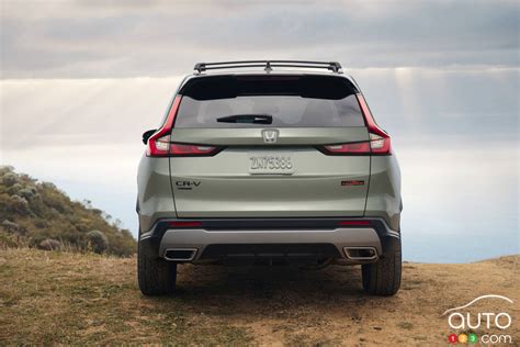 The rear of a Honda CR-V at night, with a brightly lit license plate.