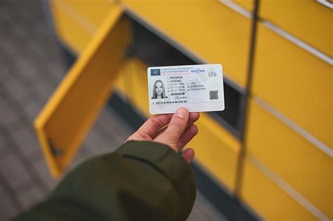 Teminė nuotrauka: žmogus, keičiantis vairuotojo pažymėjimą „Regitros“ padalinyje arba internetu, su kompiuteriu ir dokumentais.