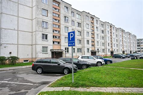 Teminė nuotrauka, vaizduojanti perpildytą daugiabučio kiemą su automobiliais