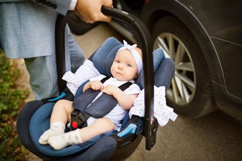 Tėvai tvirtina vaiką automobilinėje kėdutėje