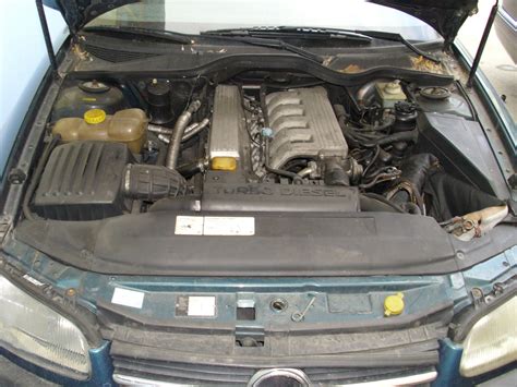 Infographics on Opel Omega 2000 engine types and fuel consumption.