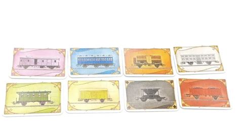 A hand of Ticket to Ride train cards showing different colors and a locomotive