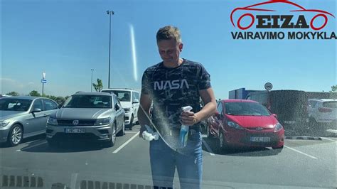 Instruktorius rūkantis automobilyje su mokiniu