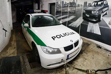 Teminė nuotrauka su policijos automobiliu ir BMW
