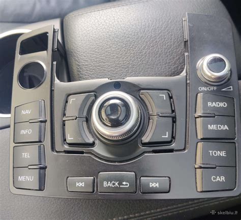 Audi MMI valdymo panelės schema su centriniu ratuku ir mygtukais