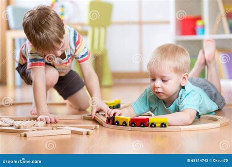 Children playing with a toy train, thematic photo