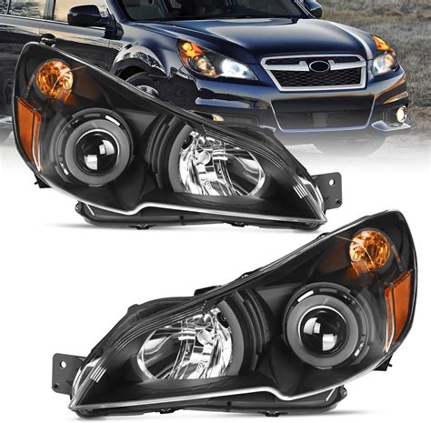 The headlights of a Subaru Tribeca at night, showing poor illumination on a wet road.