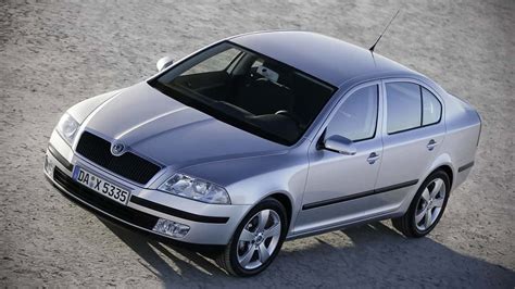 The Skoda Octavia II hatchback driving on a road in winter, snow-covered landscape